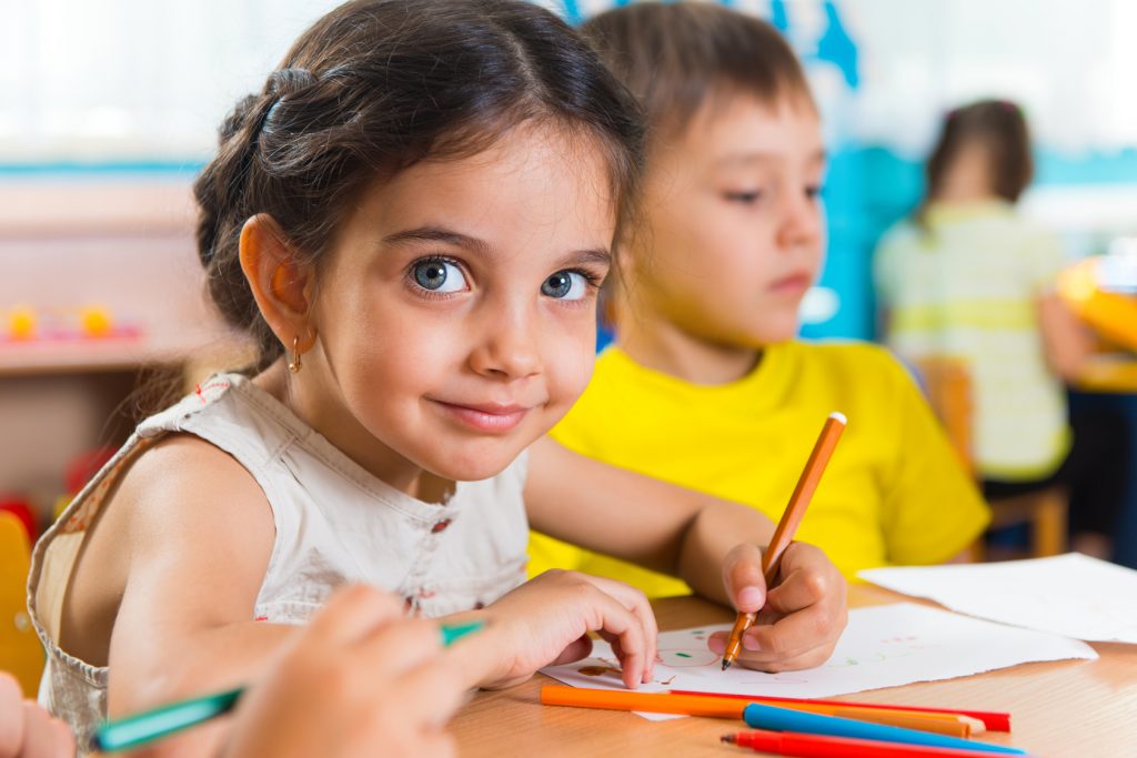 Group of cute little prescool kids drawing